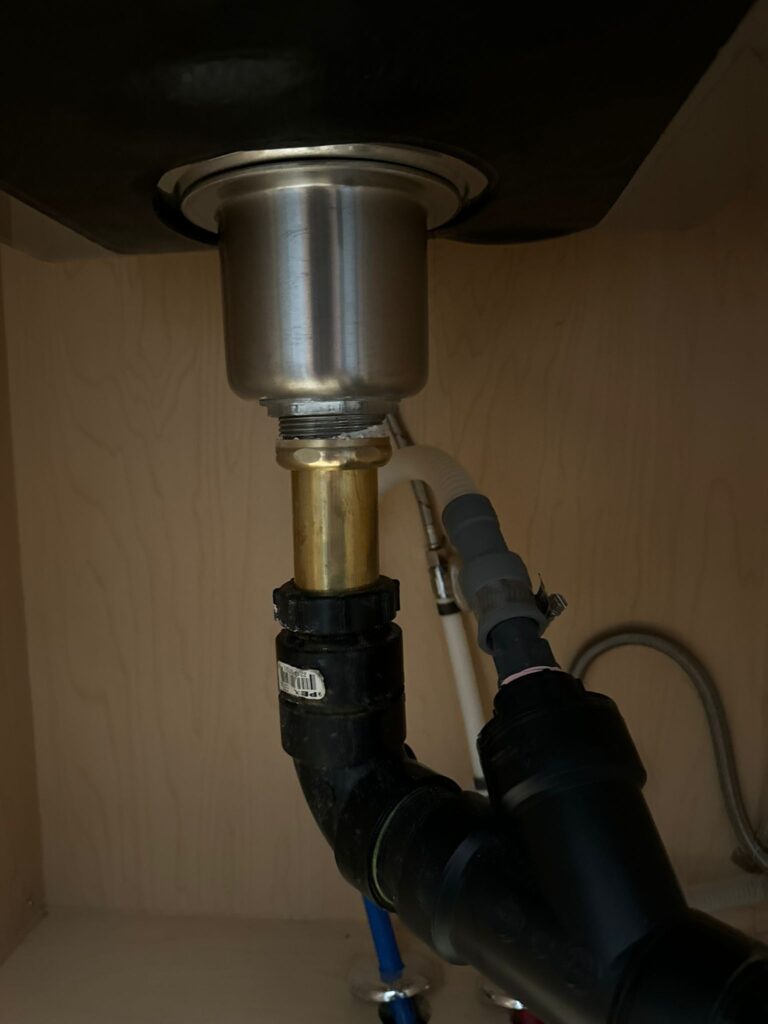 Close up of a home's sink below the countertop after it was repaired by Prosteam Mechanical plumbers