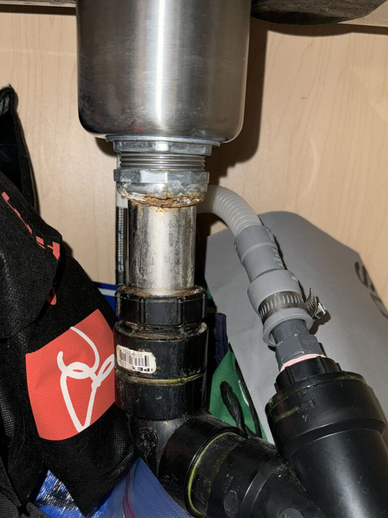 Close up of a home's sink below the countertop before it was repaired by Prosteam Mechanical plumbers