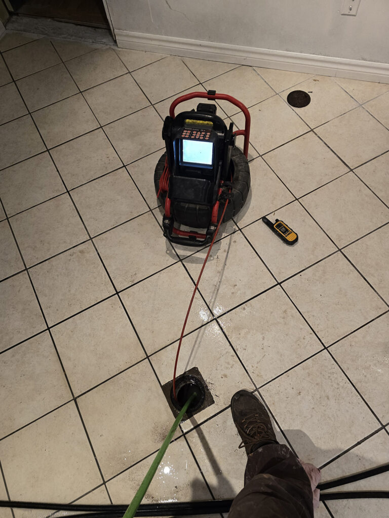 Hydro flushing being completed in the basement of a residential client's home