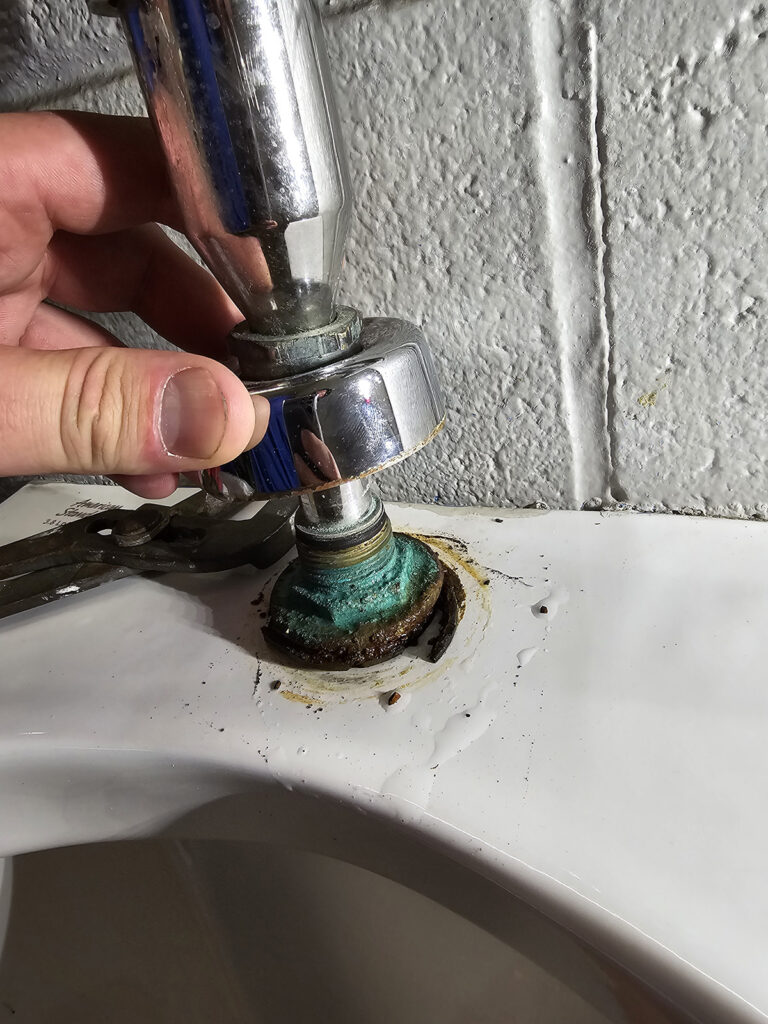 Close up of the top of a urinal as it's being repaired by a licensed Plumber from Prostream Mechanical